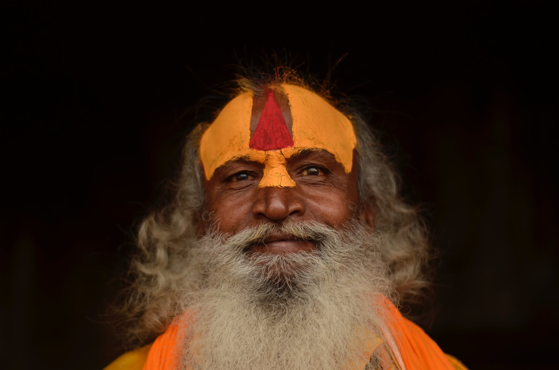man in orange shirt with white beard